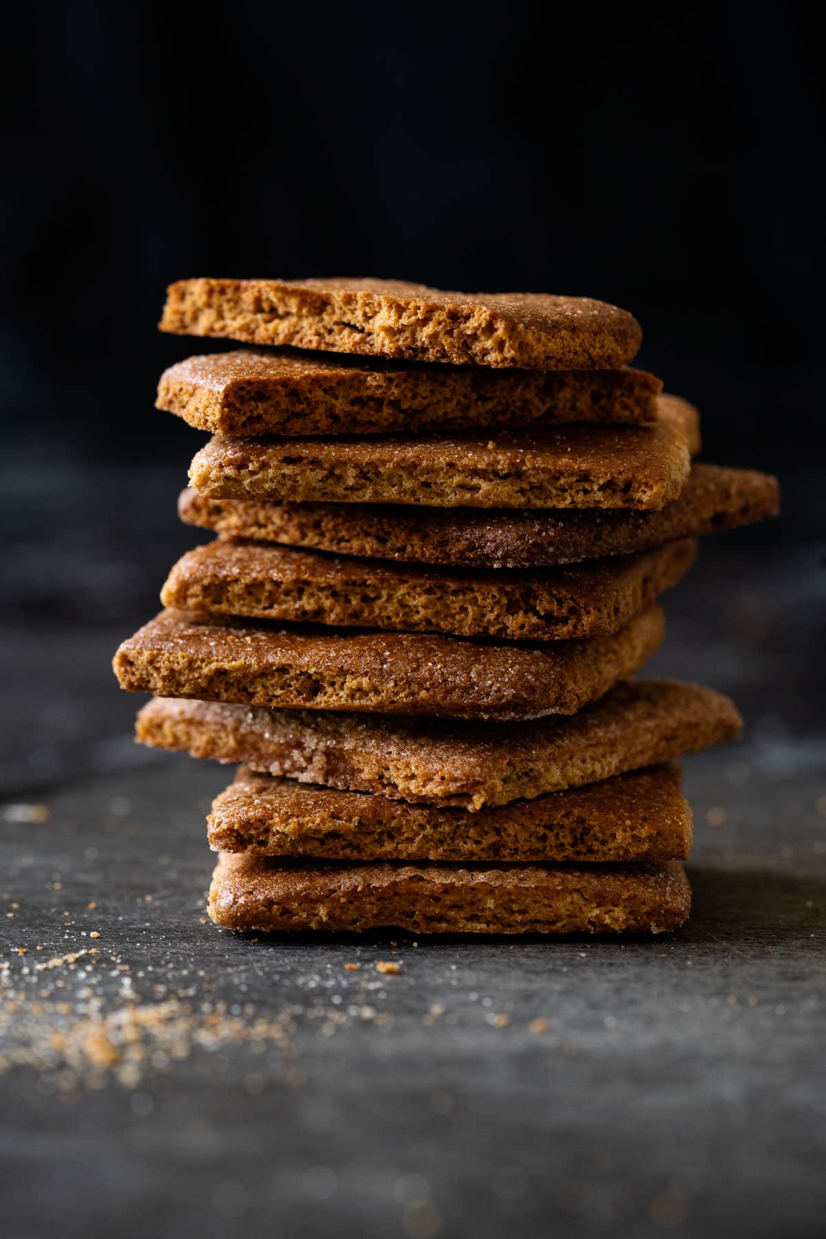 A stack of almond flour graham crackers showing their chunky, airy and crisp texture