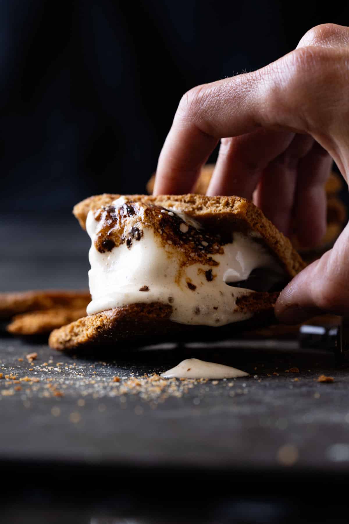 A lightly charred and melting maple syrup marshmallow s'more with almond flour graham crackers