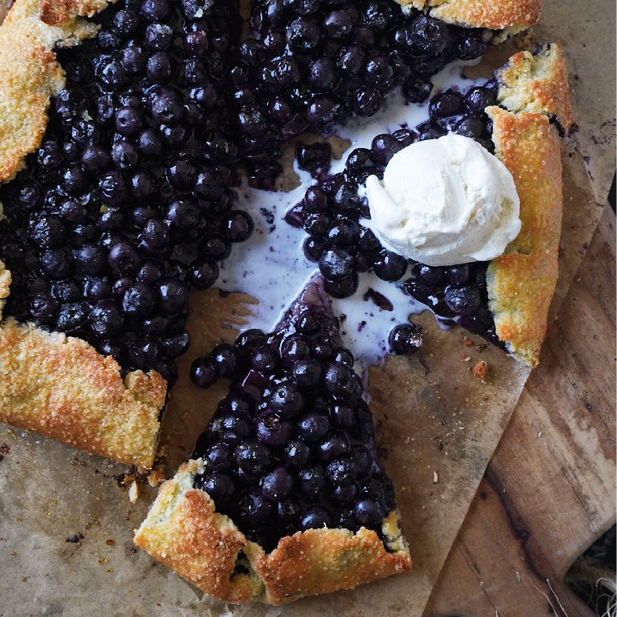 A keto blueberry galette with a scoop of vanilla ice cream
