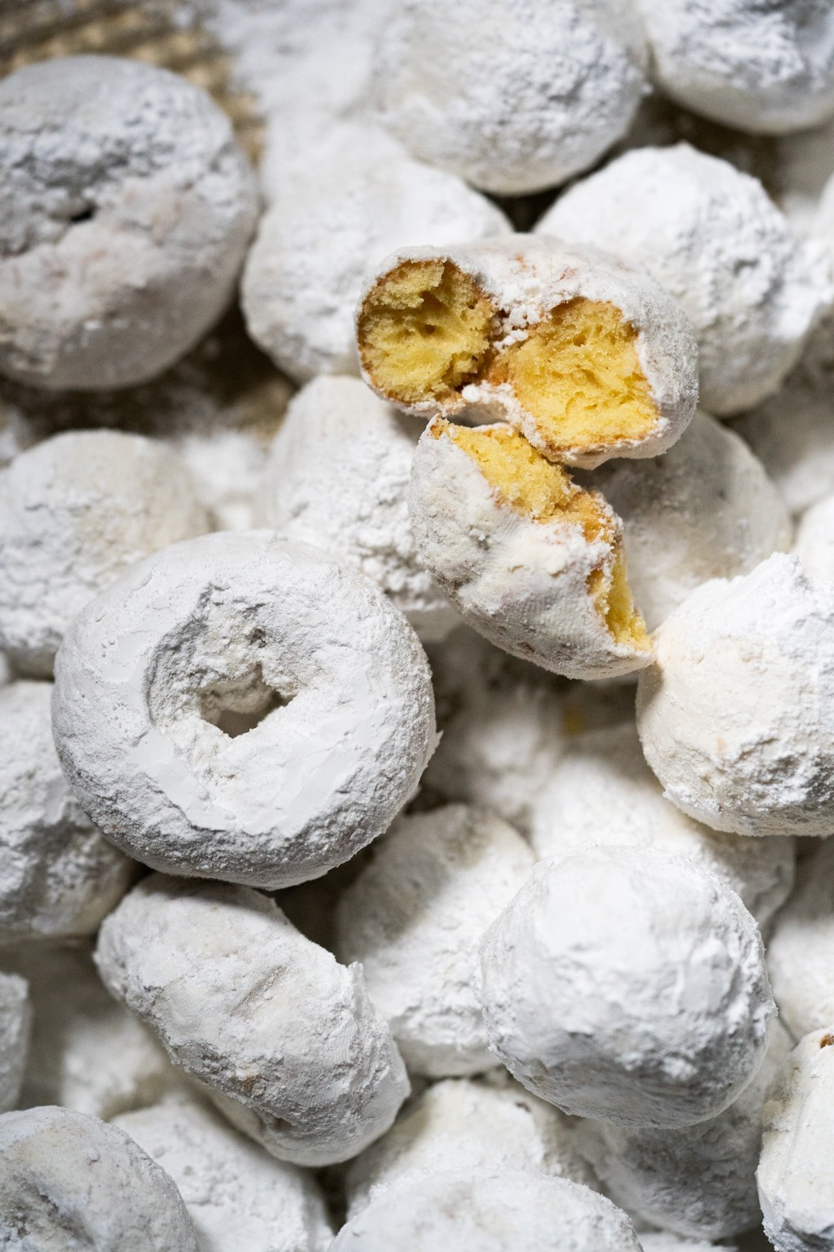 Closeup keto powdered sugar donut showing its tender texture