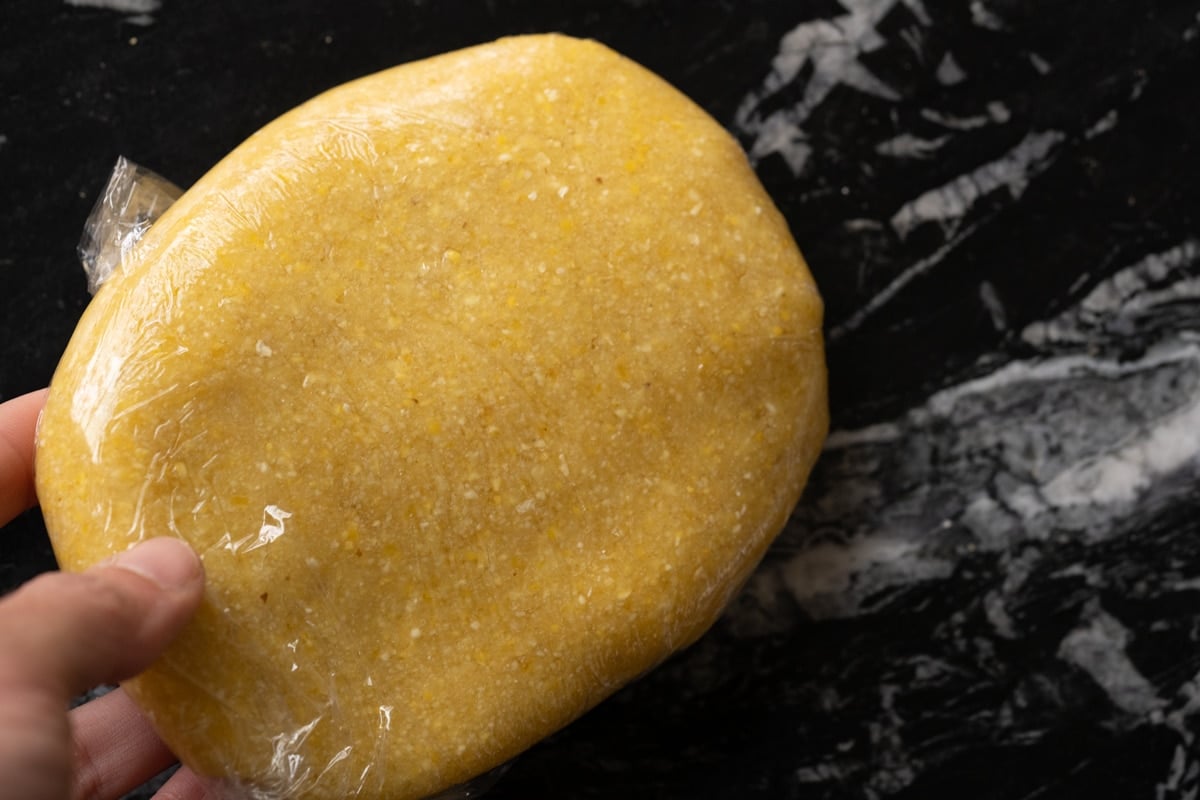 Homemade cornbread crisp dough wrapped into a flat round with film