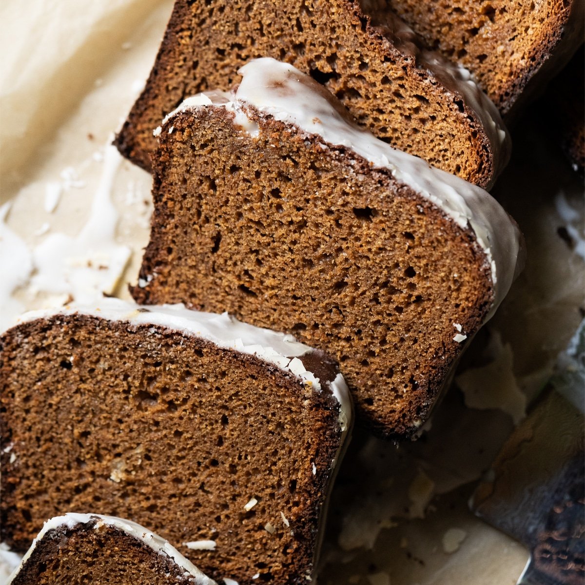 Sliced and freshly glazed low carb gingerbread loaf showing the fluffy texture