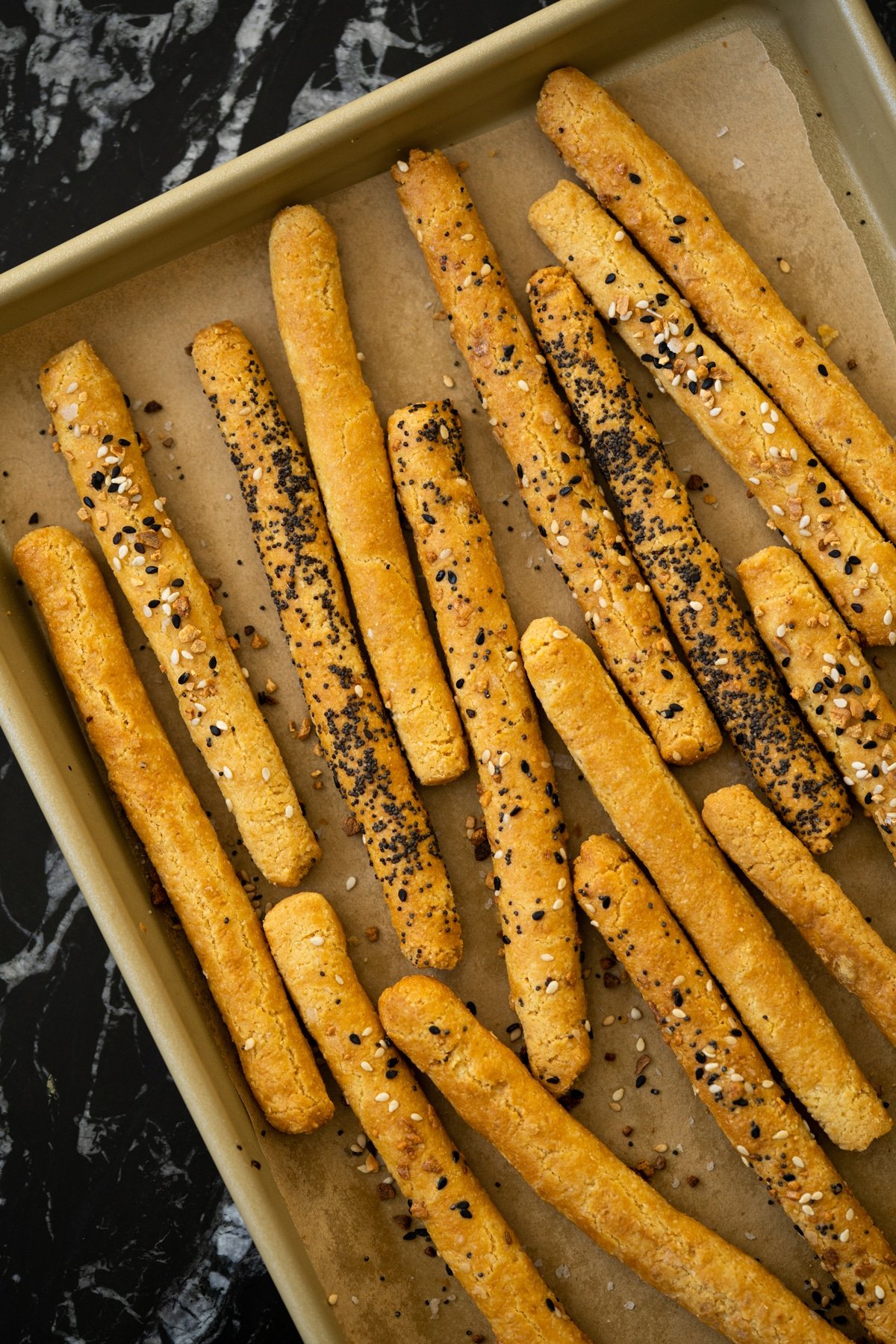 Freshly baked keto breadsticks on a baking tray