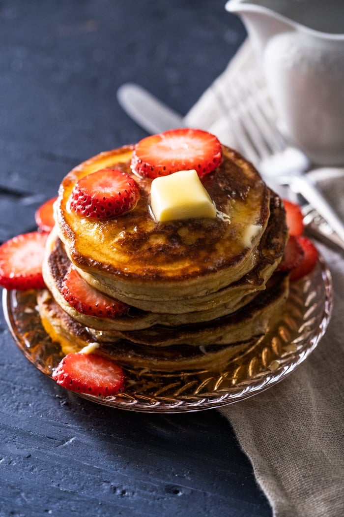 A stack of gluten free & keto pancakes with a pat of butter