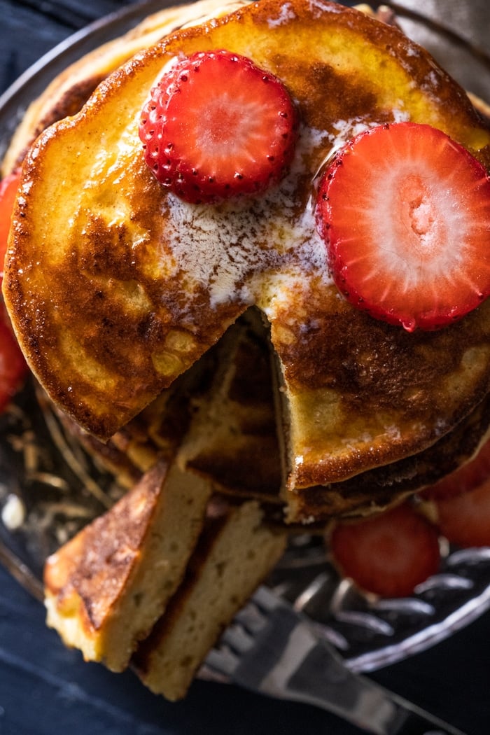 Overhead shot of cut into keto pancakes with strawberry slices