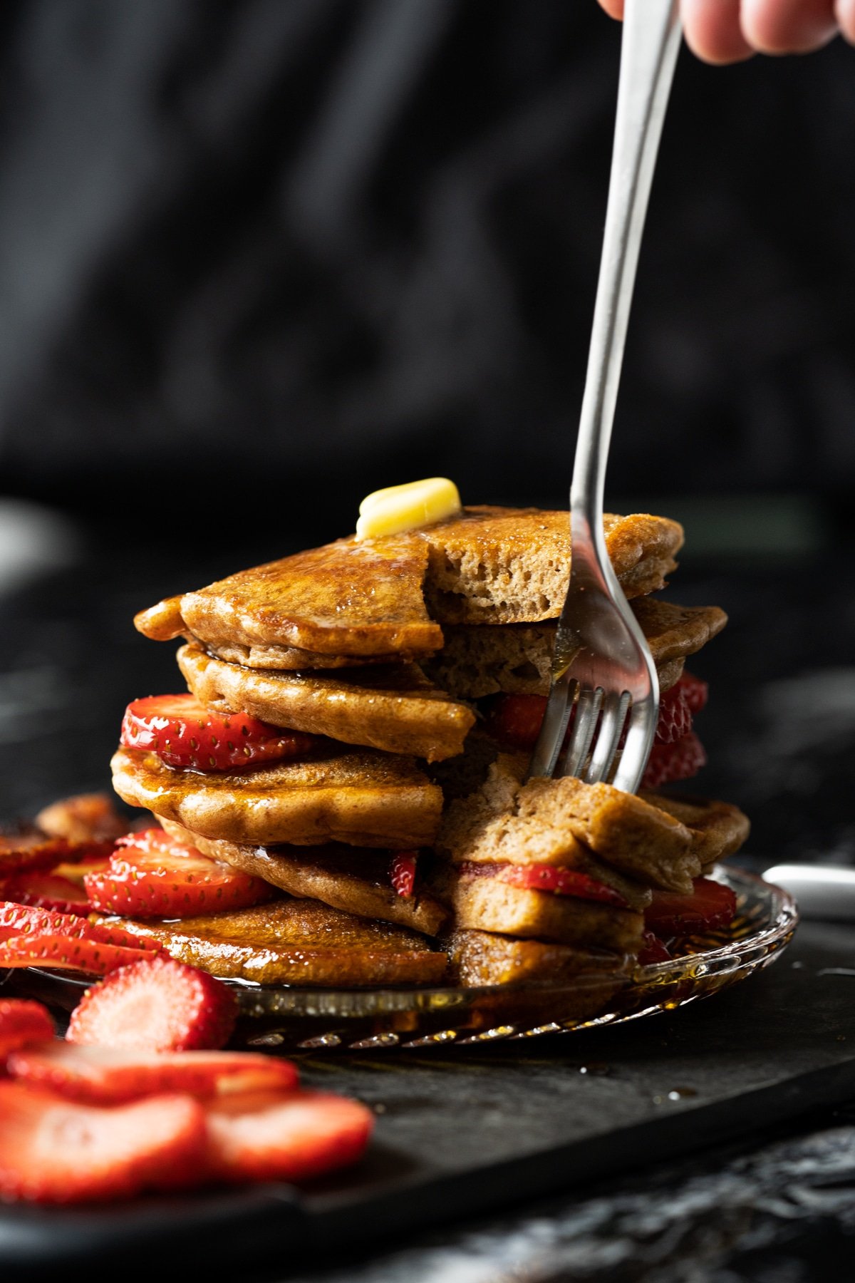 A slicked stack of flourless keto pancakes showing their fluffy texture