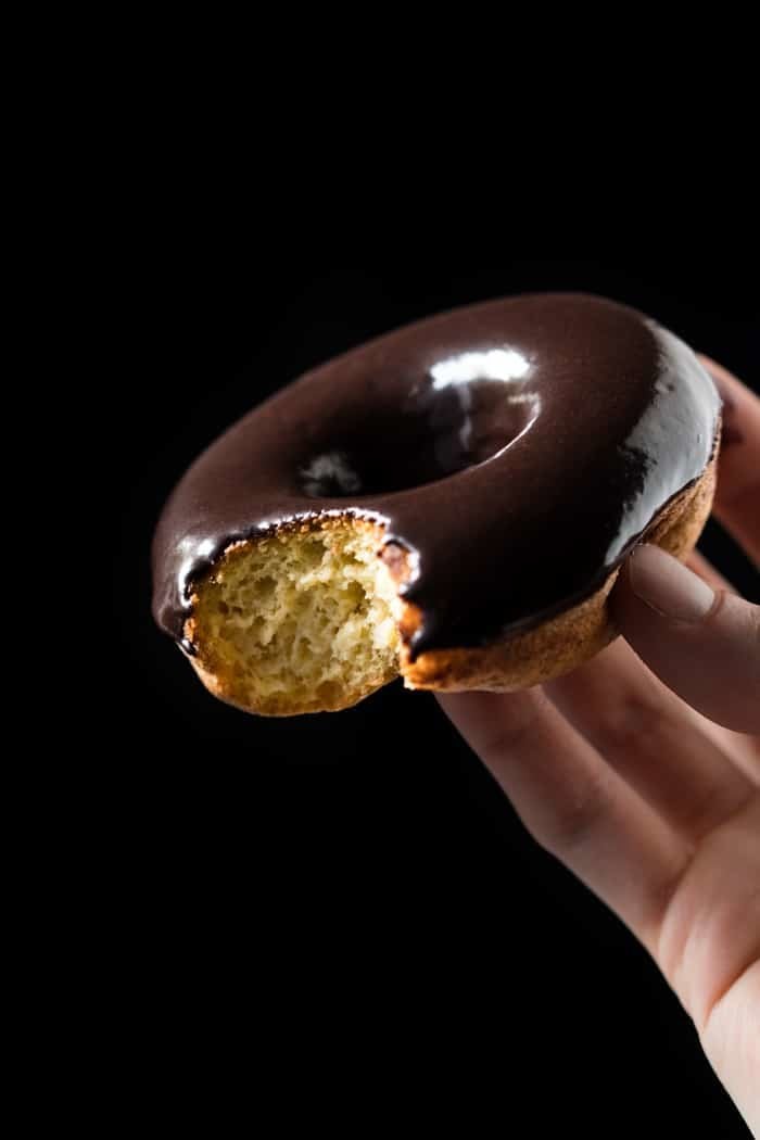 Bitten keto donut with a chocolate glaze
