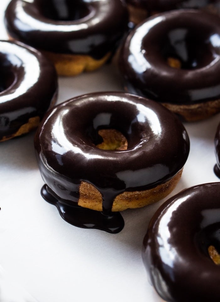 Baked keto donuts with a dripping chocolate glaze