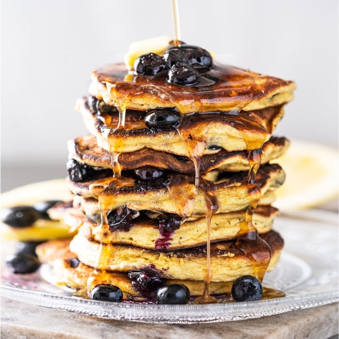 A stack of keto blueberry pancakes with sugar free syrup