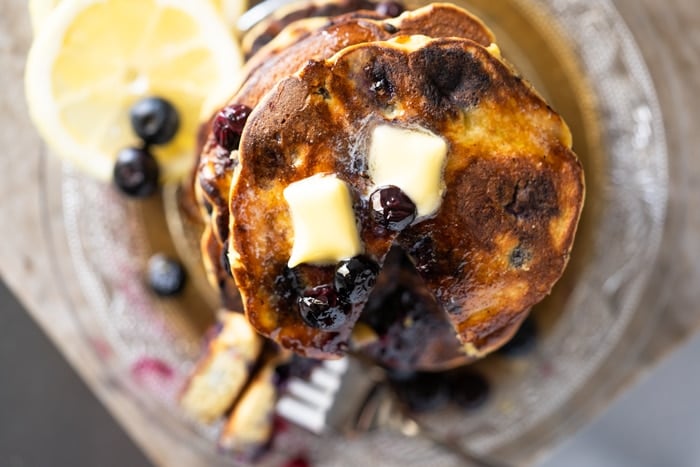 Overhead shot of Keto Blueberry pancakes with two pads of butter