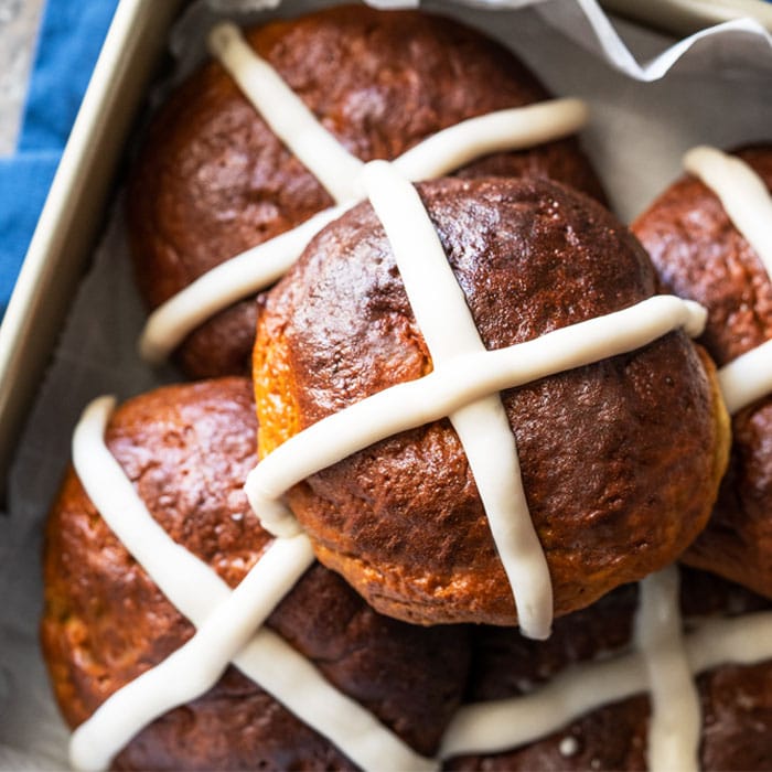 Piled up keto hot cross buns with icing