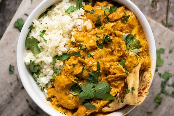 Keto naan in a butter chicken bowl with cauliflower rice