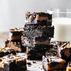 Stacked keto peanut butter brownies with a glass of milk