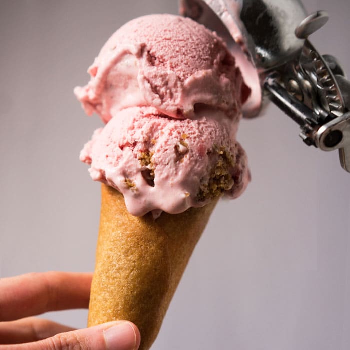Keto strawberry cheesecake ice cream with an ice cream cone