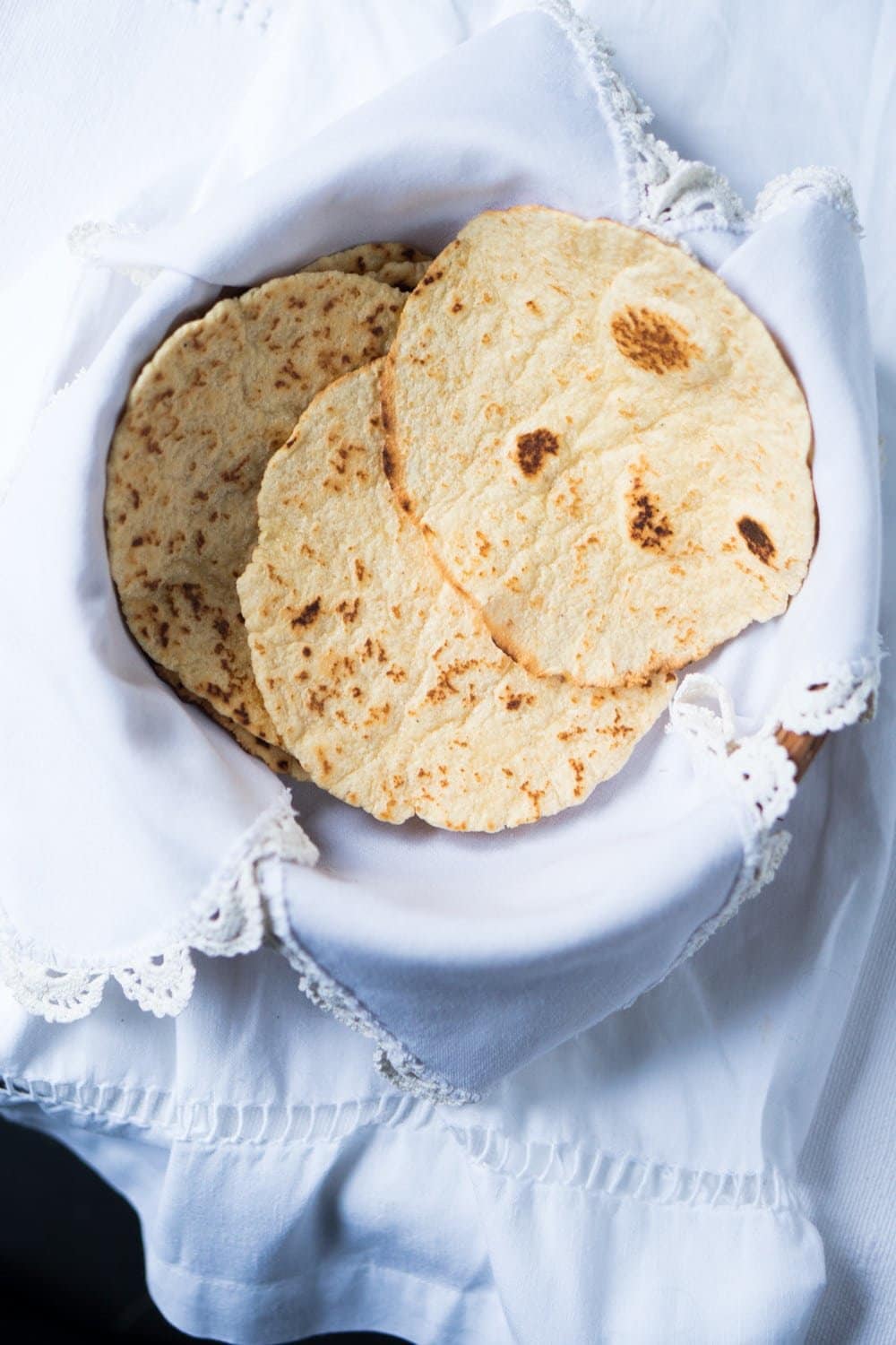 Gluten free and keto tortillas in a basket with white cloth 