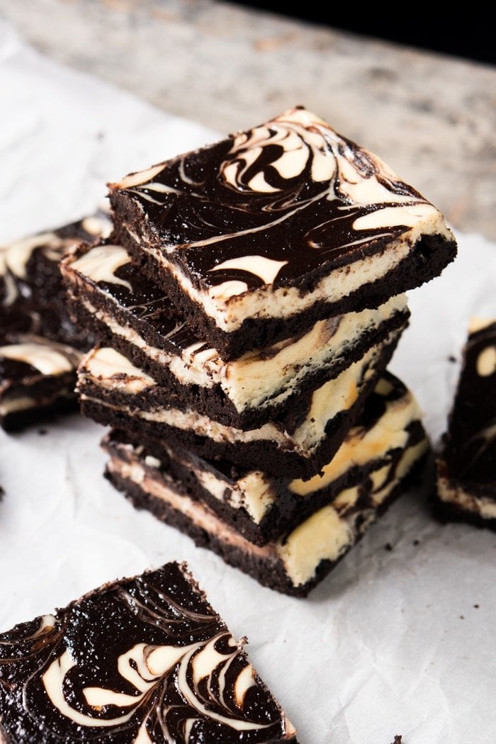 A stack of four keto cheesecake brownie squares