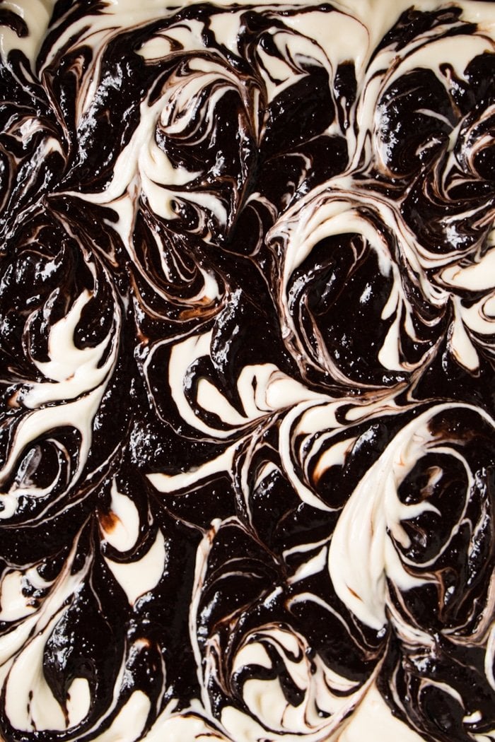 Up close shot of the unbaked keto cheesecake brownie swirls