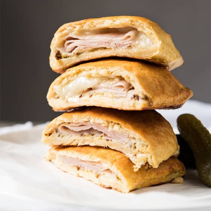 Piled up keto hot pockets with ham and cheese filling