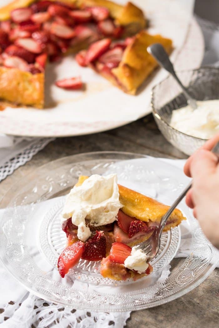 Eating a slice of keto strawberry galette with whipped cream