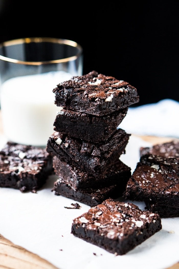 Stacked keto brownies with a glass of milk