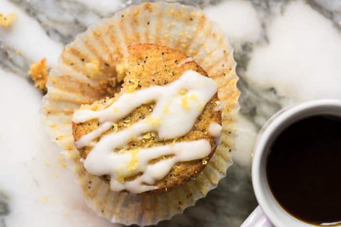 A keto lemon poppy seed muffin with a mug of coffee