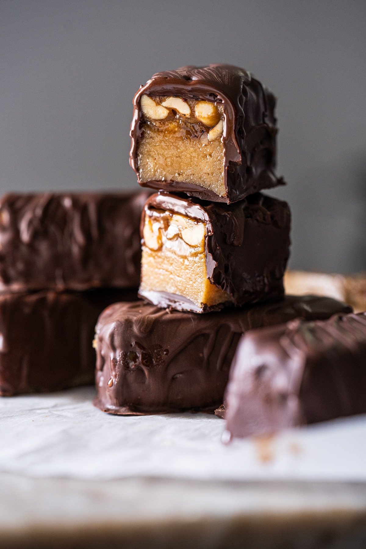Stacked keto snickers bars to show the caramel and nougat layers