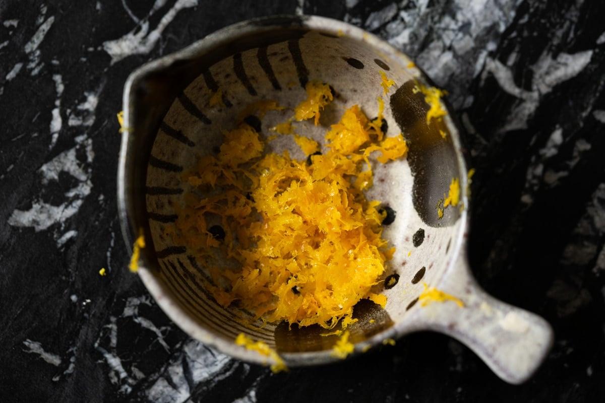 Freshly grated orange zest in a small ceramic bowl