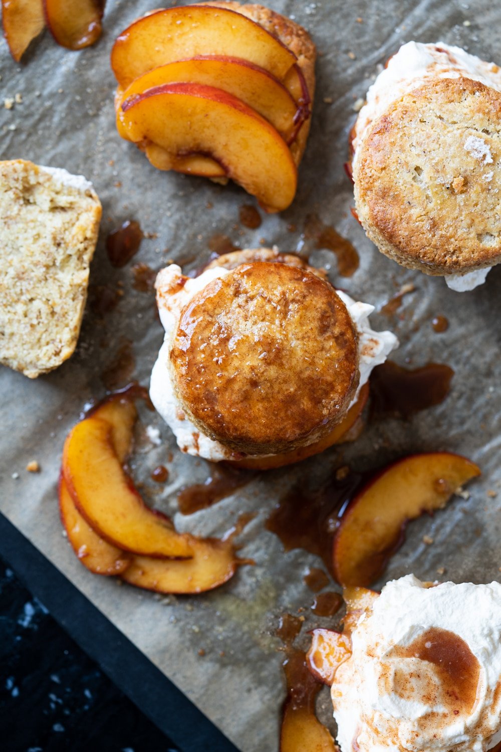 Overhead shot of keto peach shortcakes with peach slices and whipped cream