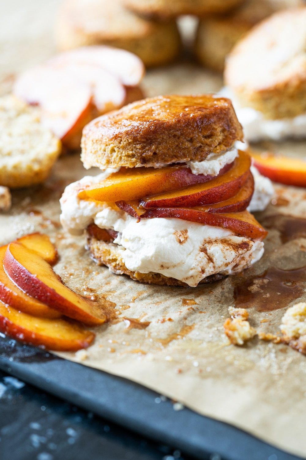 Keto peach shortcake with homemade maple whipped cream on brown parchment paper