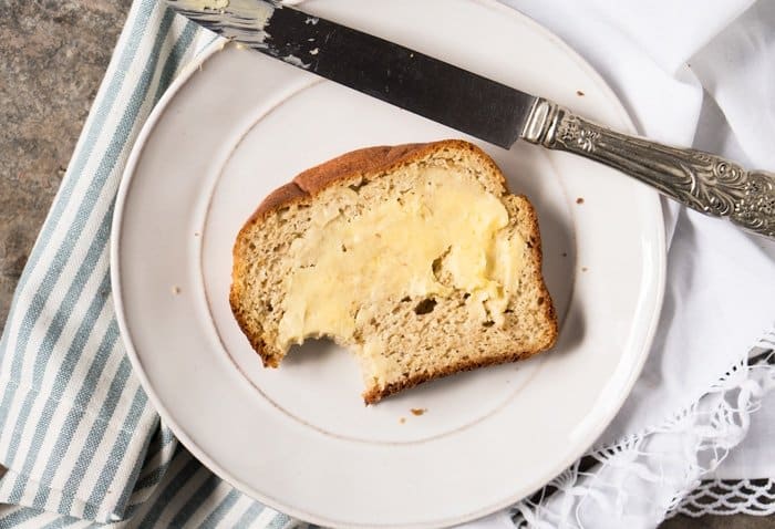 Bitten slice of keto bread with butter