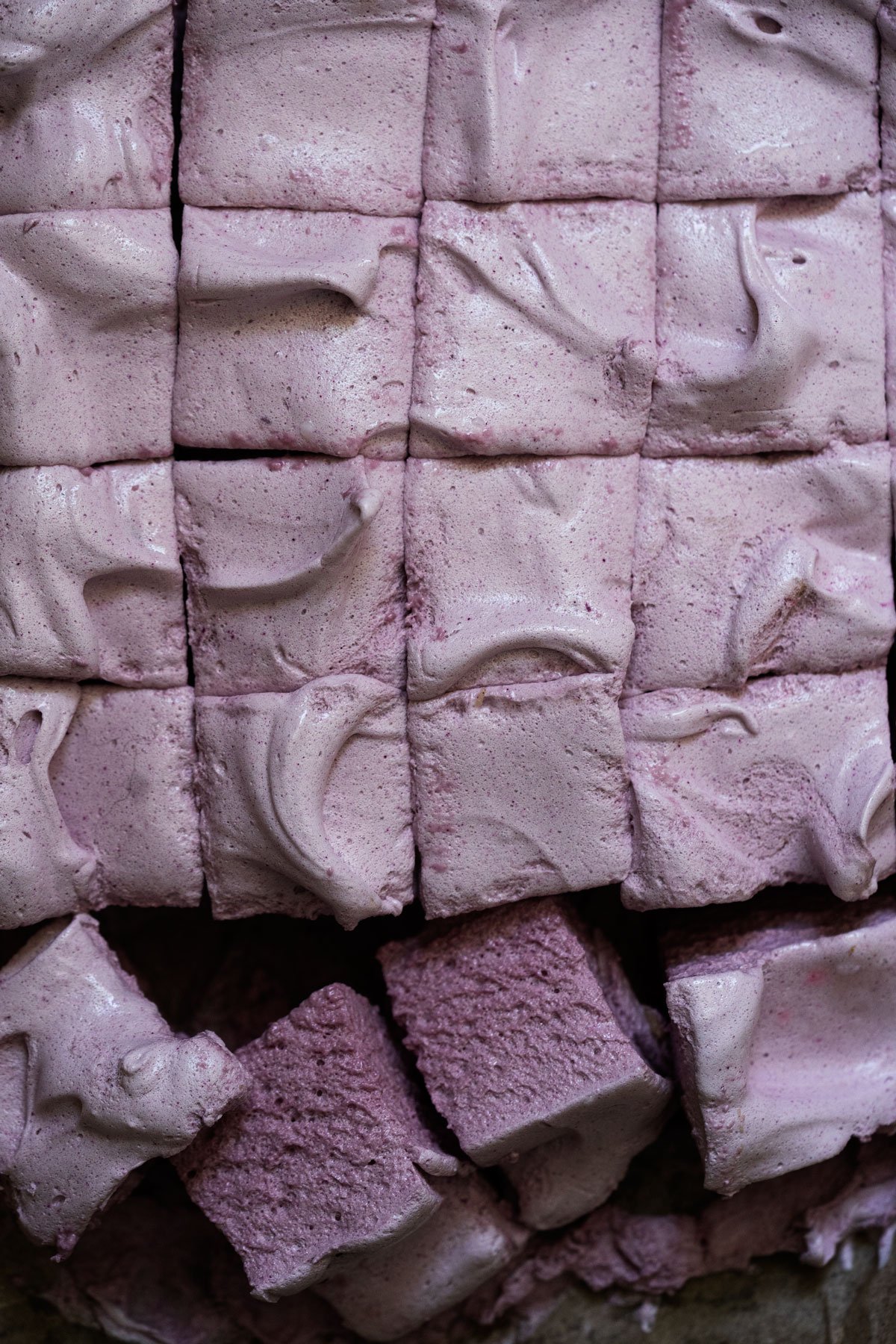 Freshly sliced maple syrup marshmallows with grape juice showing their fluffy texture and purple hue