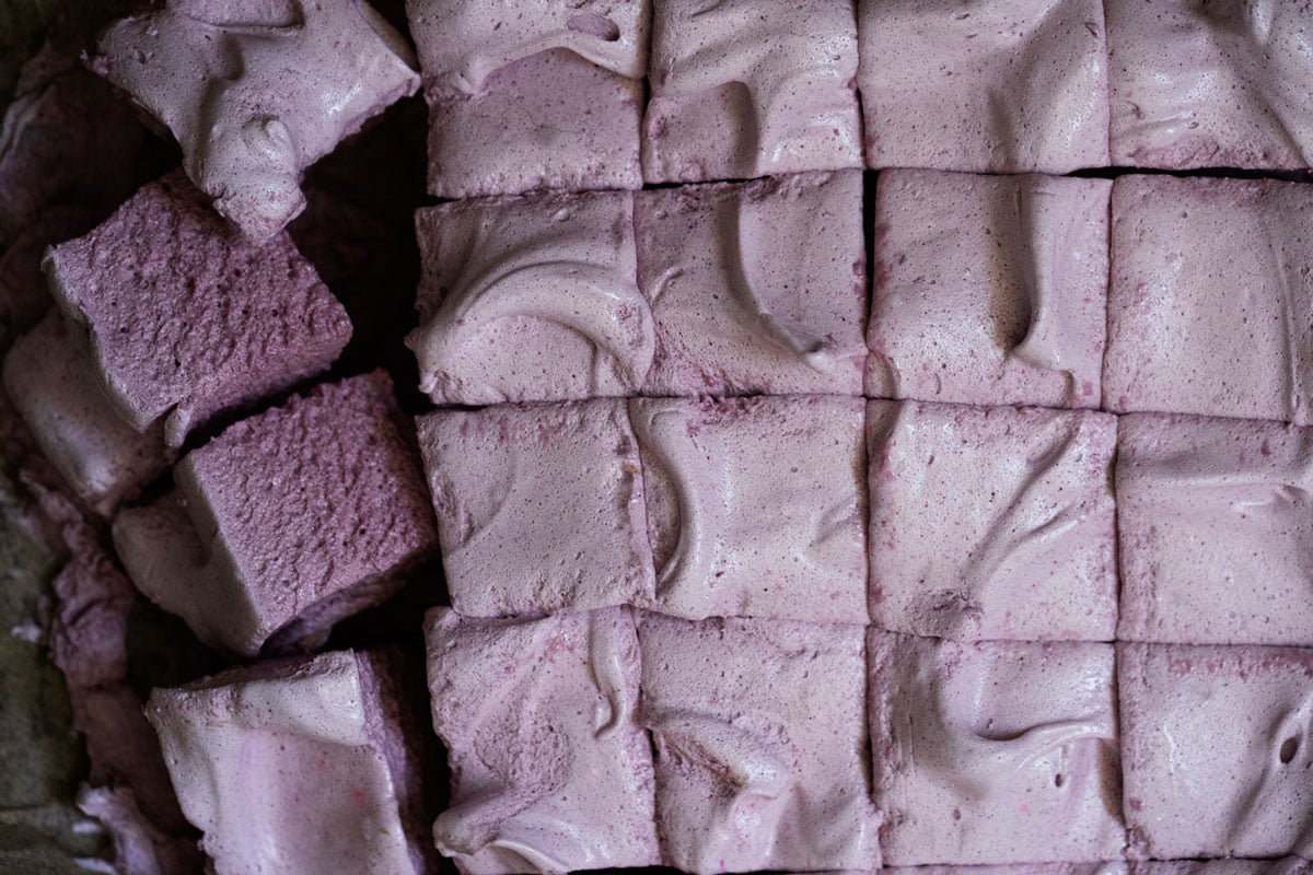 Freshly sliced maple syrup marshmallows with grape juice showing their fluffy texture and purple hue