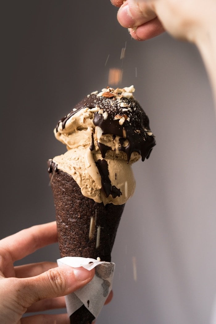 Keto coffee ice cream on a chocolate cone with a magic shell