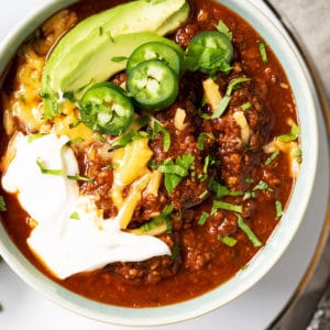 Bowl of keto chili with with toppings
