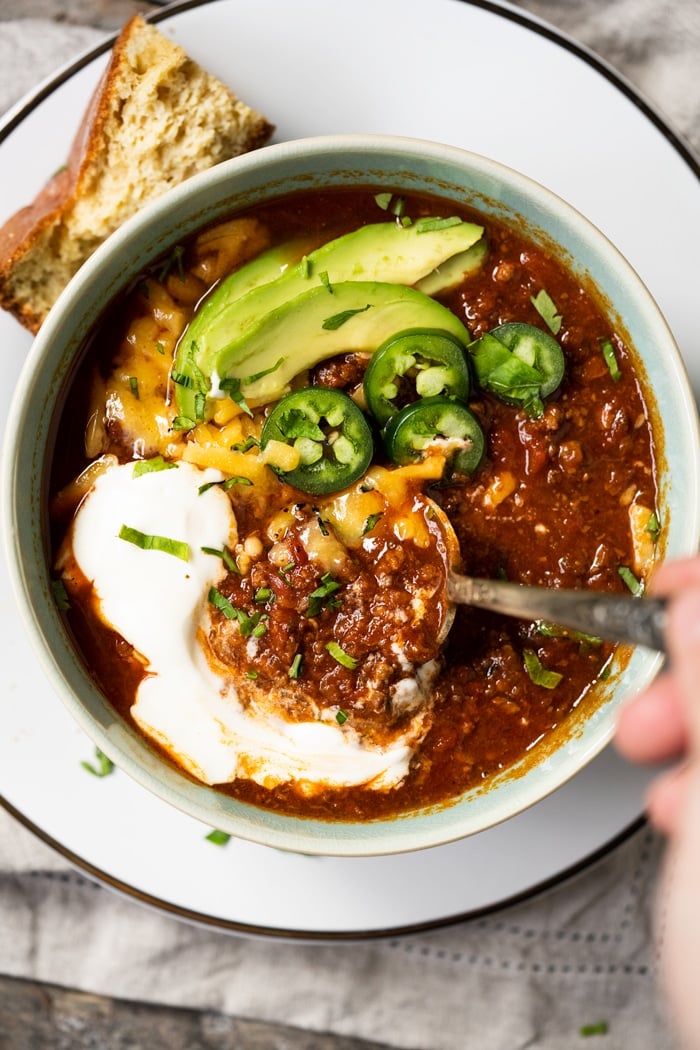 Taking a spoonful of keto chili