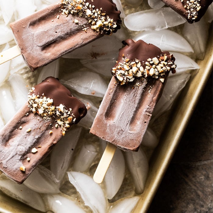 Keto chocolate popsicles dipped in chocolate and almonds