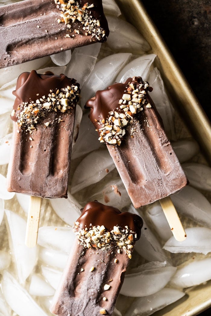 Keto chocolate popsicles dipped in chocolate and almonds