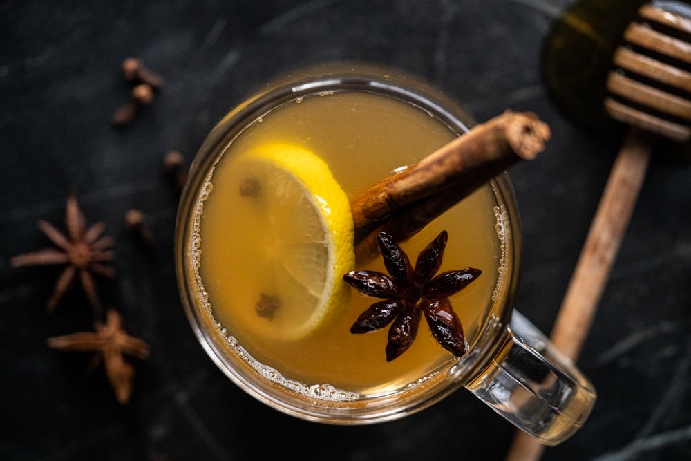 Overhead shot of a keto hot toddy over a black marble surface