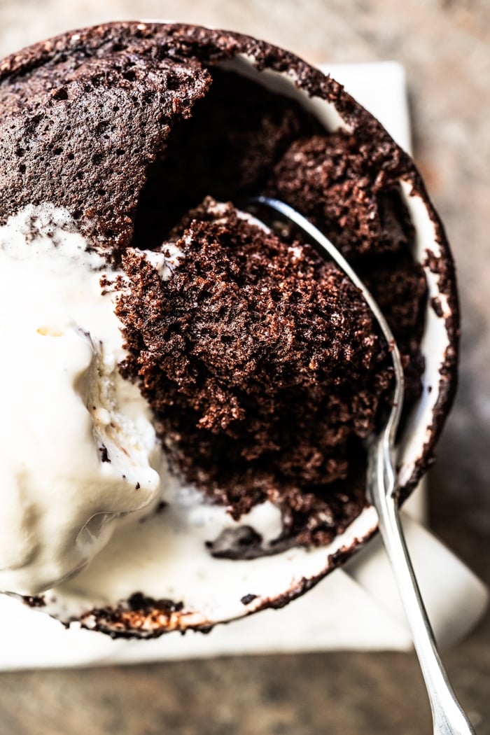 Paleo & keto mug cake with a spoon and vanilla ice cream