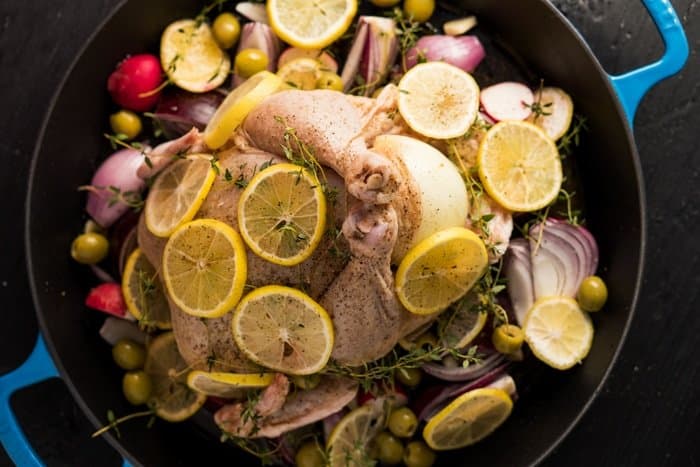 Uncooked keto roast chicken with lemon slices