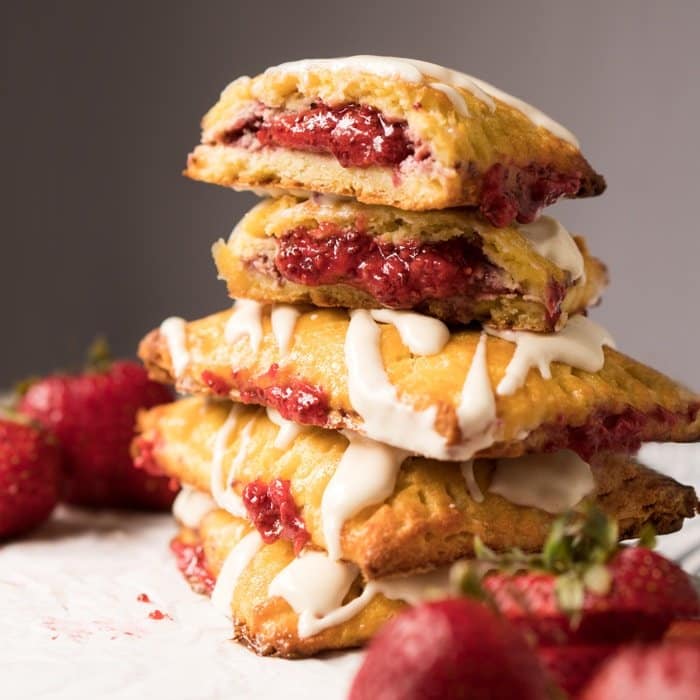 Piled up keto pop tarts with strawberry filling and cheesecake glaze