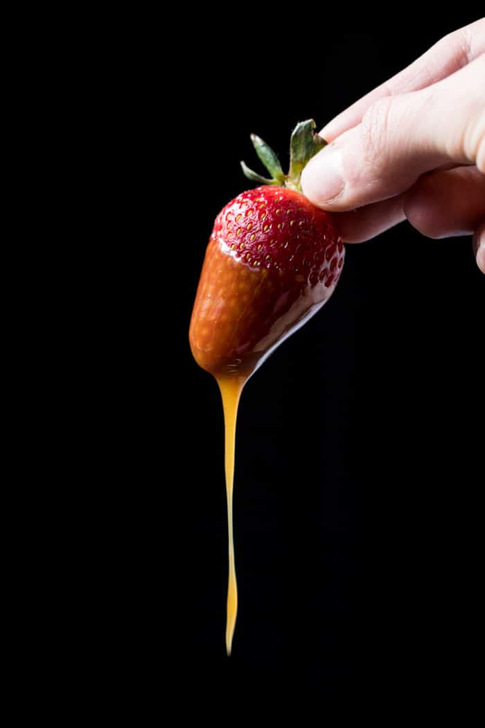 Strawberry dipped in keto caramel sauce