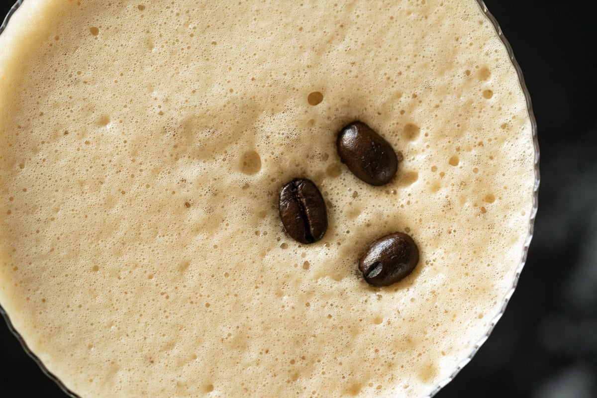 Overhead closeup of keto espresso martini with three coffee beans