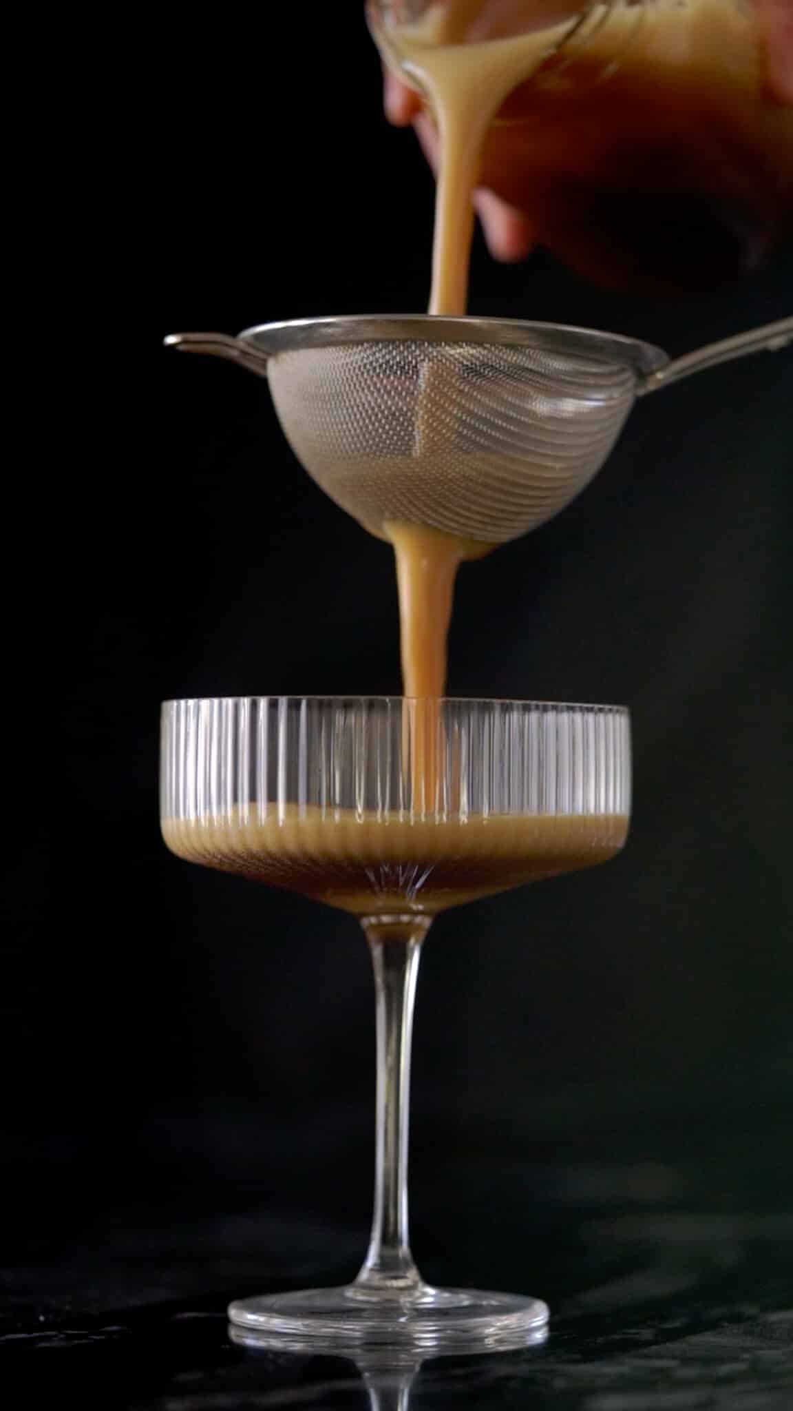 Serving the keto espresso martini through a sieve